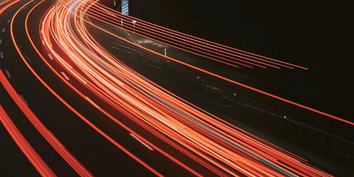 Red streaks of car lights on a highway