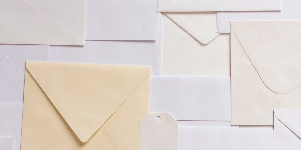 Top view of a bunch of envelopes layed out on a table